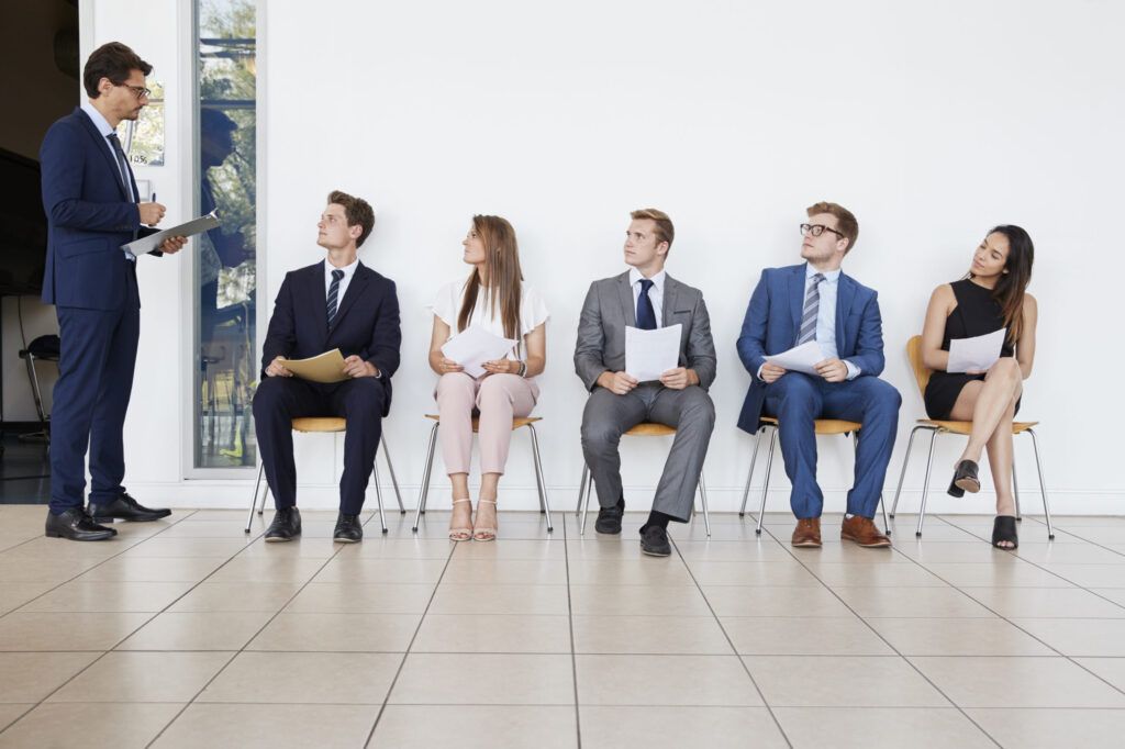 Candidates sitting in corridor on chairs waiting to be interviewed