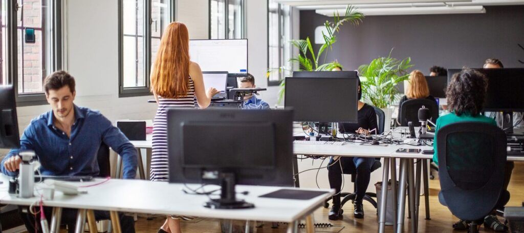 Colleagues working at desks in office