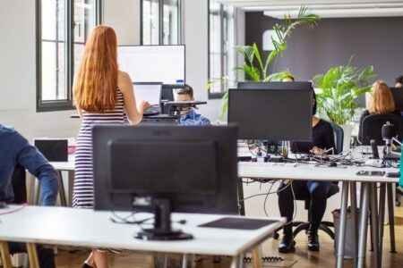 Colleagues working at desks in office