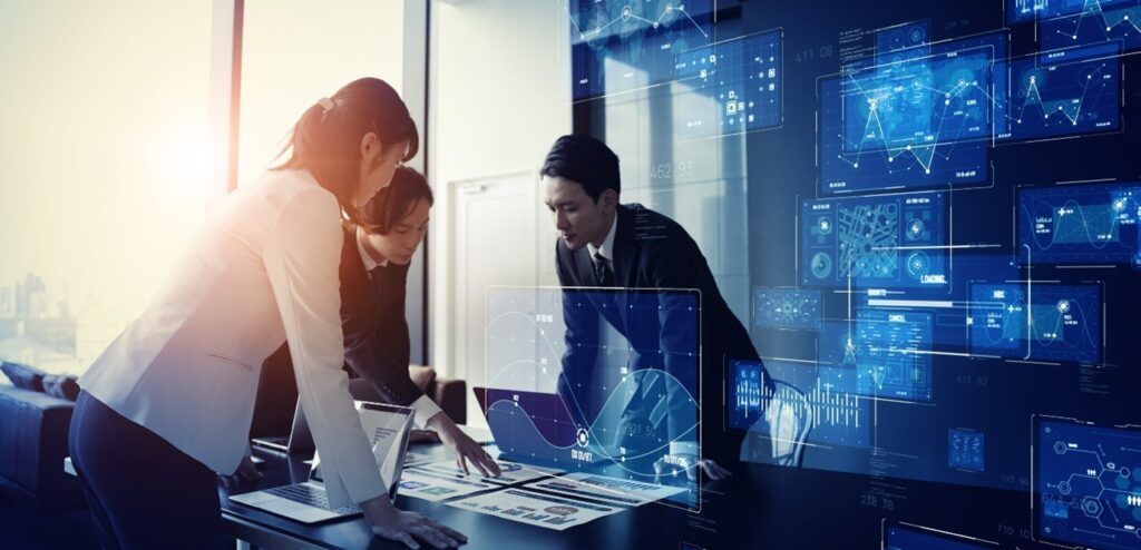 Three people brainstorming around a desk