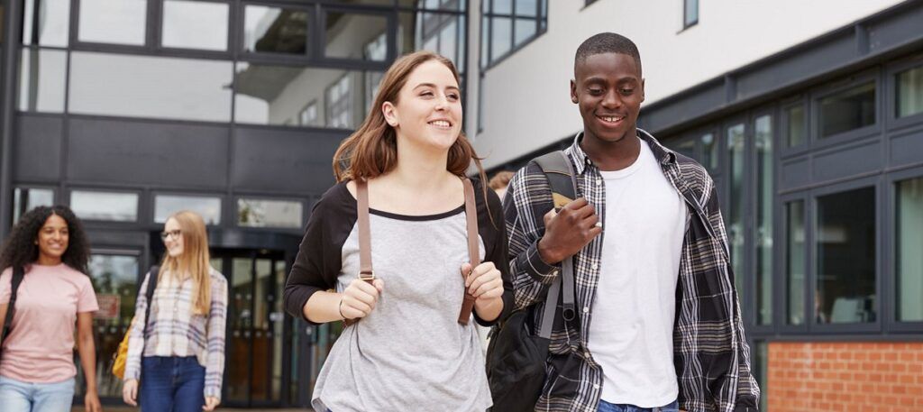 Male and female student walking around campus