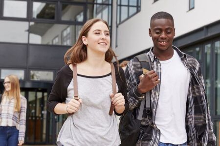 Male and female student walking around campus