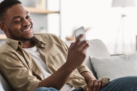 Man at home using mobile phone