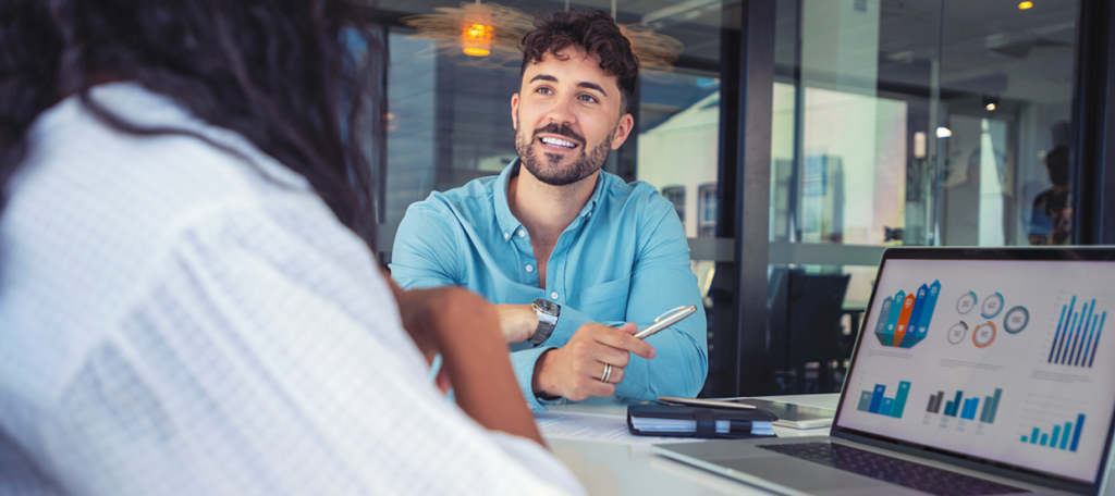 Man discussing opportunities with manager in meeting room