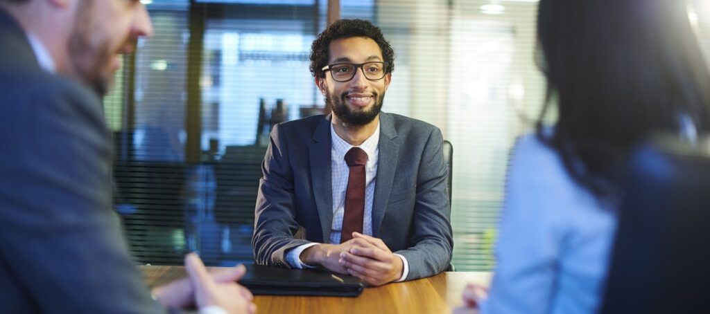 Man in suit smiling during interview