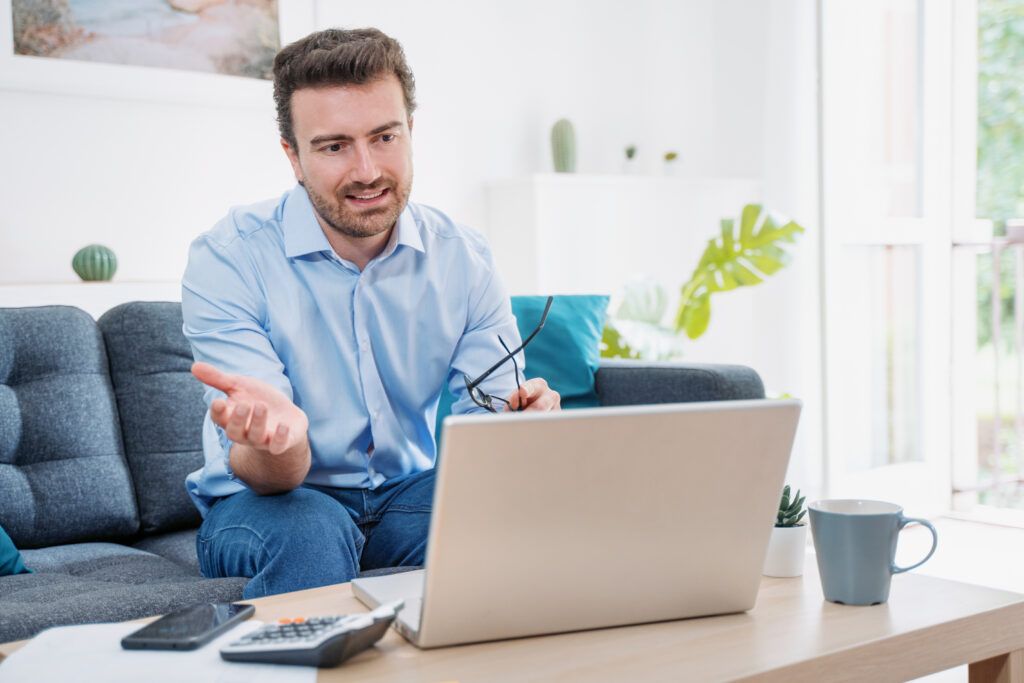 Man talking during virtual interview in living room