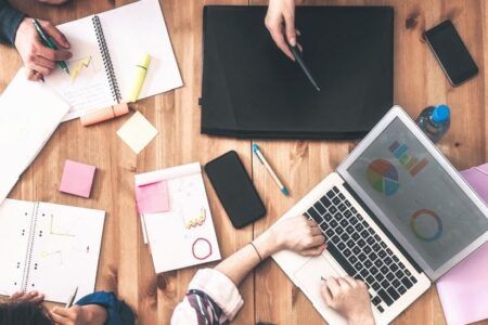 Team working on computers and tablets