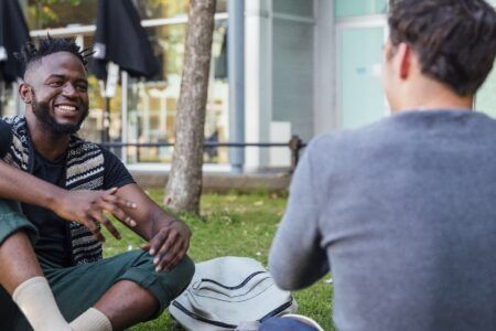 Two male students outside on campus talking