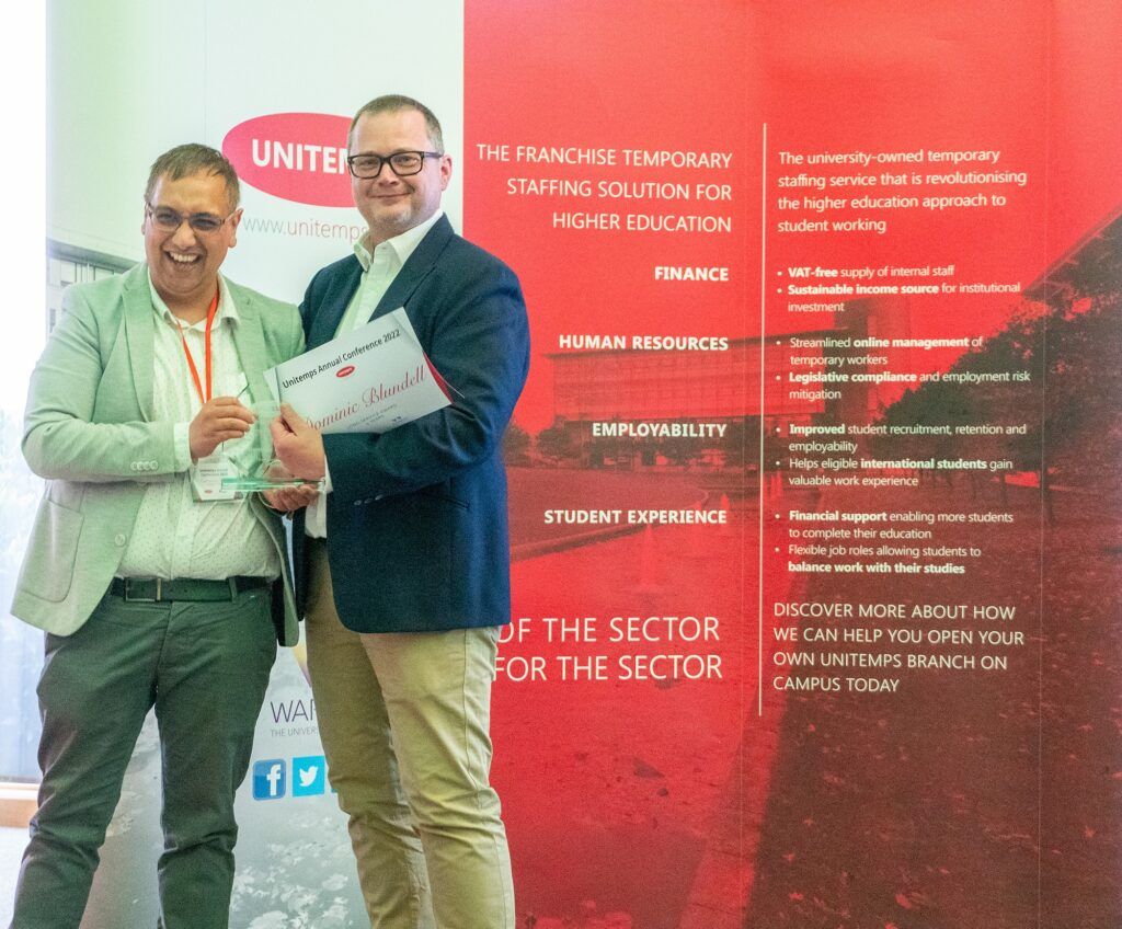Unitemps staff member Dominic Blundell receiving award