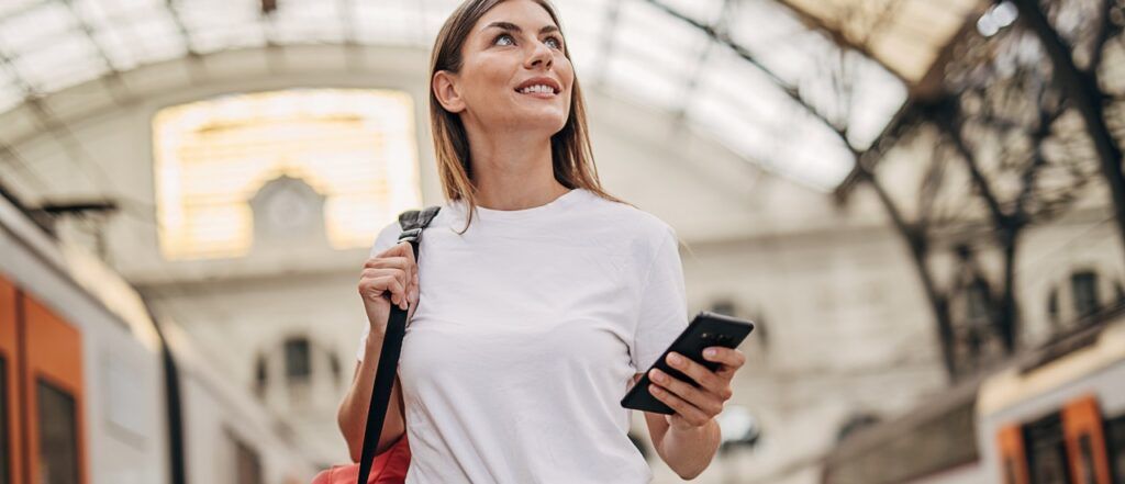 Woman walking through train station with bag