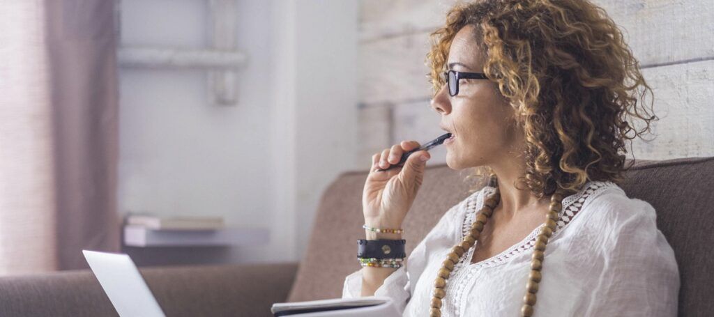 Woman working on laptop on couch