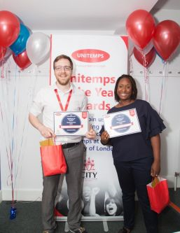 man and woman holding certificates and goody bag at unitemps of the year awards at city university