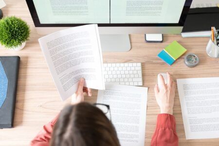 woman at desk going through paperwork